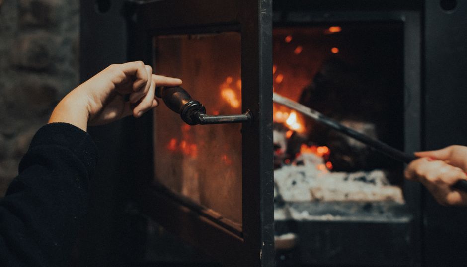 Atizando la estufa de leña antes del desayuno